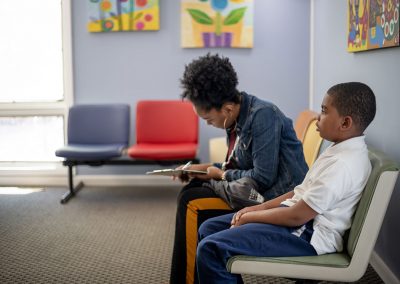 pediatric services - parent filling out paperwork in waiting room